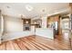 Inviting living room with a stone fireplace, open to a modern kitchen with stainless steel appliances and lots of natural light at 42299 Kingsmill Cir, Elizabeth, CO 80107