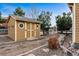 Backyard view of the storage shed with small circular windows and double doors at 42299 Kingsmill Cir, Elizabeth, CO 80107