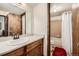 Bathroom featuring warm wood vanity and bath-shower combo at 325 Four O Clock Rd # 303, Breckenridge, CO 80424