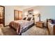 Comfortable bedroom with warm lighting, wood accents, and plush carpeting at 325 Four O Clock Rd # 303, Breckenridge, CO 80424
