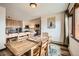 Dining area with wooden furniture, view of kitchen, and artwork on wall at 325 Four O Clock Rd # 303, Breckenridge, CO 80424