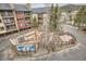 Aerial view of the hot tub area and a nearby wooden deck with red chairs for outdoor enjoyment at 325 Four O Clock Rd # 303, Breckenridge, CO 80424