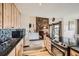 Open kitchen view with wooden cabinets and stainless steel appliances, flowing into the living room at 325 Four O Clock Rd # 303, Breckenridge, CO 80424