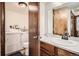 Combined laundry and bathroom featuring a sink, toilet, and washer/dryer units at 325 Four O Clock Rd # 303, Breckenridge, CO 80424