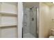 Bathroom featuring a glass door shower, built in shelves, and toilet at 1850 Folsom St # 411, Boulder, CO 80302