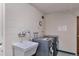 Functional laundry room with modern washer and dryer and utility sink at 1850 Folsom St # 411, Boulder, CO 80302