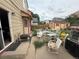 Untidy backyard featuring a shed, a patio area with furniture, and some overgrown plants at 14874 E 52Nd Ave, Denver, CO 80239