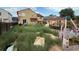 Overgrown backyard with tall grass, building materials and various items scattered around at 14874 E 52Nd Ave, Denver, CO 80239