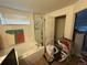 Bathroom with tub, shower, and toilet, showing clutter and items scattered around at 14874 E 52Nd Ave, Denver, CO 80239