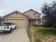 Two-story home with a two-car garage and a well-maintained lawn at 14874 E 52Nd Ave, Denver, CO 80239