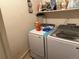 Laundry room featuring a modern washer and dryer set with shelving for storage at 14874 E 52Nd Ave, Denver, CO 80239