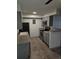 Galley kitchen featuring gray cabinets, stainless steel appliances, and tile flooring at 7000 W 20Th Ave # 106, Lakewood, CO 80214