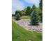 Landscaping with decorative rock bed and evergreen shrubs enhances the property's curb appeal at 7000 W 20Th Ave # 106, Lakewood, CO 80214