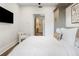 Stylish bedroom featuring a modern chair, decorative art, and a glimpse into the bathroom at 2506 16Th St, Denver, CO 80211