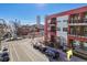 Modern red building with balconies against a blue sky with city views in the background at 2506 16Th St, Denver, CO 80211