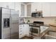 Modern kitchen showcasing stainless steel appliances, white cabinets, and sleek countertops, designed for functionality at 2506 16Th St, Denver, CO 80211