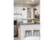 Contemporary kitchen area with a stainless steel refrigerator, modern cabinets, and a bar counter with stools at 2506 16Th St, Denver, CO 80211
