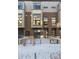 Modern brick townhome with private patio and snow-covered front yard at 4060 W 16Th Ave, Denver, CO 80204