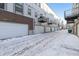 Row of garages with snow-covered driveway at 4060 W 16Th Ave, Denver, CO 80204