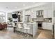 Modern kitchen with white cabinets, stainless steel appliances, and breakfast bar at 4060 W 16Th Ave, Denver, CO 80204