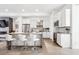Modern kitchen with white cabinets, stainless steel appliances, and breakfast bar at 4060 W 16Th Ave, Denver, CO 80204