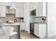 Modern kitchen with white cabinets, stainless steel appliances, and breakfast bar at 4060 W 16Th Ave, Denver, CO 80204