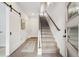 Stylish staircase with modern light wood and barn door at 4060 W 16Th Ave, Denver, CO 80204
