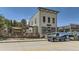 Commercial building with outdoor seating and two branded vans parked in front at 241 Paloma Way, Elizabeth, CO 80107