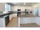 Modern kitchen with white cabinets, gray countertops, and stainless steel appliances at 241 Paloma Way, Elizabeth, CO 80107