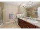 Bathroom featuring a double sink vanity, shower, and ample counter space for storage at 8617 Gold Peak Dr # G, Highlands Ranch, CO 80130