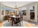 Cozy dining area with large windows, backyard access, and a rustic wood dining set at 8617 Gold Peak Dr # G, Highlands Ranch, CO 80130