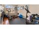 Bright exercise room with large windows and equipment including a treadmill and rowing machine at 8617 Gold Peak Dr # G, Highlands Ranch, CO 80130