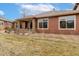 An expansive lawn and a cozy stone patio create a welcoming outdoor space for relaxation at 8617 Gold Peak Dr # G, Highlands Ranch, CO 80130