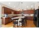 Well-equipped kitchen with dark wood cabinets, granite countertops, and bar stool seating at 8617 Gold Peak Dr # G, Highlands Ranch, CO 80130