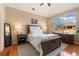 Relaxing main bedroom with wood flooring, large windows, and neutral wall paint at 8617 Gold Peak Dr # G, Highlands Ranch, CO 80130