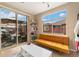 Bright sun room with natural light, a contemporary sofa, and access to the outdoor patio area at 8617 Gold Peak Dr # G, Highlands Ranch, CO 80130