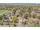 Picturesque neighborhood view showcasing mature trees, lush green lawns, and a scattering of beautiful homes at 3889 S Fraser St, Aurora, CO 80014