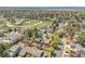 Residential neighborhood showcasing charming homes, winding streets, and a park area, surrounded by mature trees at 3889 S Fraser St, Aurora, CO 80014