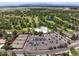 Aerial view of the community amenities including a swimming pool, tennis courts, and parking at 3889 S Fraser St, Aurora, CO 80014