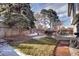 Lush backyard with a patio, a garden area, a wooden fence, and mature trees, creating a private outdoor oasis at 3889 S Fraser St, Aurora, CO 80014