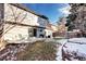 Expansive backyard featuring a concrete patio, lush lawn, garden beds, and mature trees for outdoor enjoyment at 3889 S Fraser St, Aurora, CO 80014