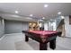 Basement featuring a billiards table with access to stairs and a kitchenette at 3889 S Fraser St, Aurora, CO 80014