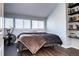 Bedroom featuring a bed and workout equipment and built-in shelves filled with books at 3889 S Fraser St, Aurora, CO 80014