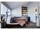 Bedroom featuring a bed and workout equipment, a mini-fridge and a shelf for displaying books at 3889 S Fraser St, Aurora, CO 80014
