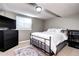 Cozy bedroom featuring a metal bed frame, neutral walls, carpet, and a window for natural light at 3889 S Fraser St, Aurora, CO 80014