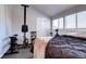 Bedroom featuring hardwood floors, a large window and an indoor rowing machine at 3889 S Fraser St, Aurora, CO 80014