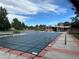 Community pool covered for the winter, surrounded by sidewalks and grassy areas at 3889 S Fraser St, Aurora, CO 80014
