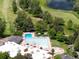 Aerial shot of the sparkling community pool with sun umbrellas and lounge seating areas at 3889 S Fraser St, Aurora, CO 80014