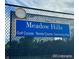 Meadow Hills community sign featuring golf course, tennis courts and swimming pool amenities at 3889 S Fraser St, Aurora, CO 80014