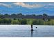 Scenic lake view with mountains in the background with person on stand up paddleboard at 3889 S Fraser St, Aurora, CO 80014